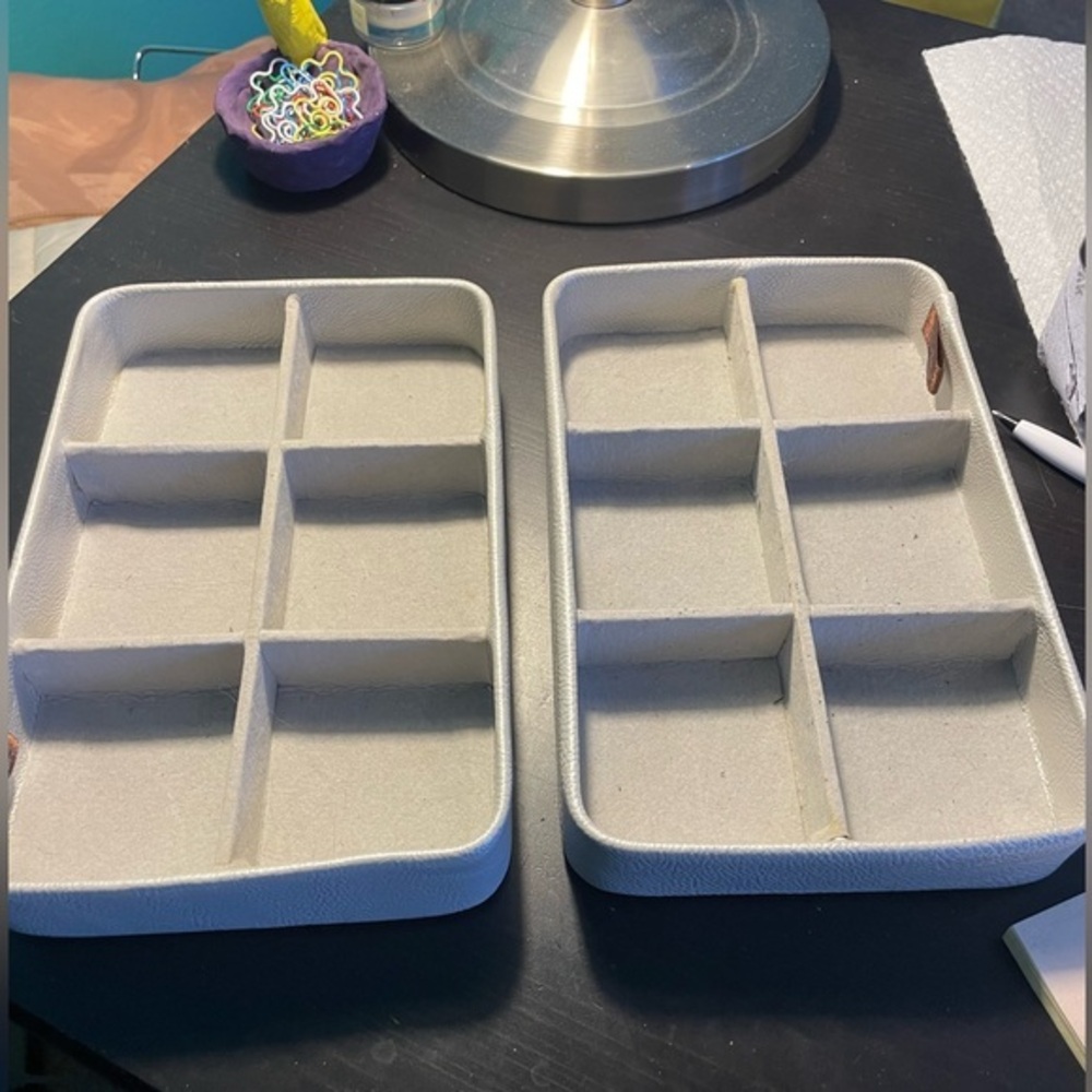 Two gray velvet jewelry display cases